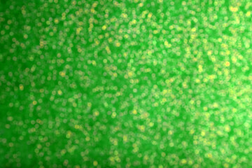 St. Patrick day. Green glitter as background, blurred view. Bokeh effect