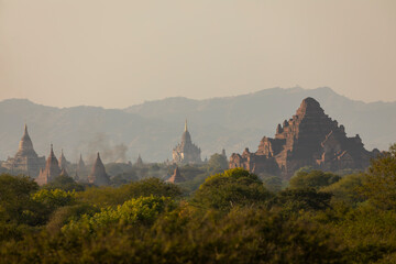 A landscape of mountains, temples and pagodas, immersed in the haze, dust and dry forest that...
