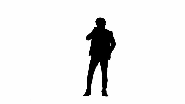 Portrait of male model in studio isolated on white background with alpha channel. Silhouette of businessman in suit dancing at the camera.