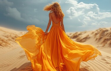 Fototapeta premium The concept of a youthful, attractive girl in a dress in a desert of sand. Idea of the desert queen