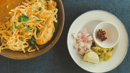 Northern Thai food it called Khao Soi Kai, egg noodle soup with chicken and a mix of deep fried egg noodles served with pickled mustard greens, shallots and lime