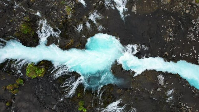 Aerial view of bridge leading over Bruarfoss Waterfall, Iceland.