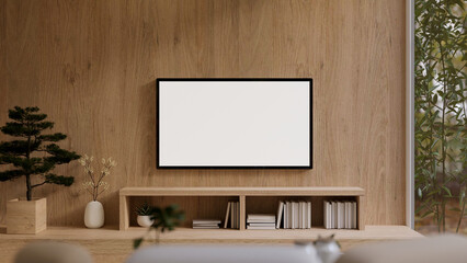 A modern white TV monitor mockup on a wooden wall in a modern, expensively furnished living room.