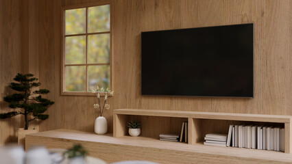 A TV monitor on a wooden wall above a wooden cabinet in a modern, expensively furnished living room.