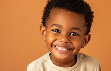 Portrait of a child black boy against a light brown background