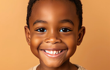 Portrait of a child black boy against a light brown background