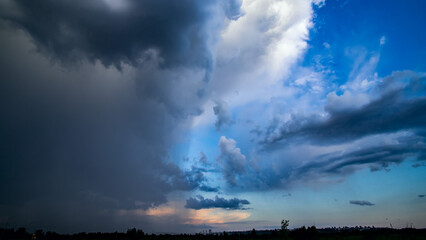 Stormy sky with dramatic clouds from an approaching thunderstorm at summer sunset