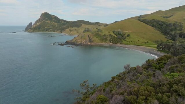 Aerial: headland and ocean in Fletcher Bay, Coromandel Peninsula, New Zealand.