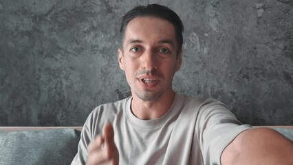 Videoblogger greets his audience on camera snapshot of modern digital professions Videoblogger connecting with viewers in online world. Each video is new chapter in videoblogger's internet saga.