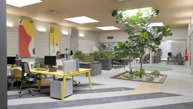 Slow establishing shot of an empty office with abstract artwork hanging 