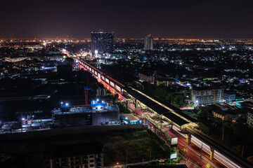 long exposure shot cityscape and electric train station at nighttime,