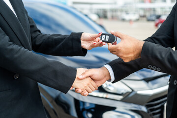 Young asian businesswoman buying new car with sale manager. she getting key and go to driving car...