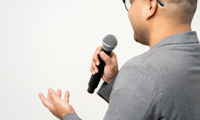 Close up businessman speaker hand holding High quality dynamic microphone and singing song or...