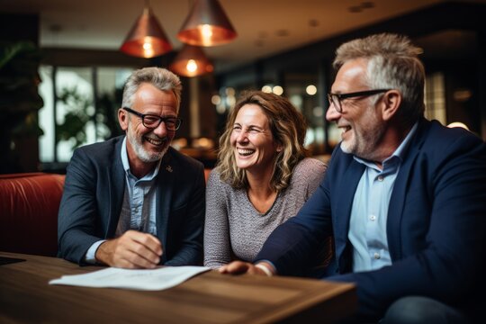 Mature Couple Discussing Investment Strategies With Their Financial Advisor In A Cozy Office, Generative AI