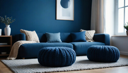Two knitted poufs near dark blue corner sofa  Scandinavian home interior design of modern living room  style
