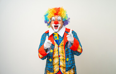 Mr Clown. Portrait of Funny comedian face Clown man in colorful uniform wearing wig standing pointing finger to camera. Happy expression amazed face male bozo in various pose on isolated background.