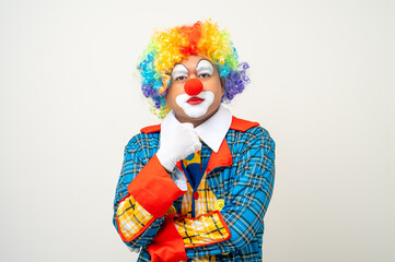 Mr Clown. Portrait of Funny face Clown man in colorful uniform standing and thinking. Happy...