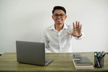 smiling young asian businessman in a workplace counting five with fingers wear white shirt with glasses isolated