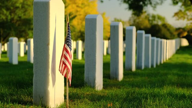 members graves with American flags at sunset in the National Cemetery. Unknown soldier grave. Veteran cemetery and U.S. flag. Military Appreciation Holidays concept