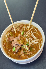 Vietnamese Rice Noodles Soup with Vietnamese Sausage served vegetables and crispy onion - Asian food style
