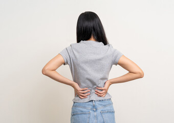 Young woman has problem with structural posture She had back pain. She massaged her back for relief reduce muscle tension. Woman suffering from back ache unwell on isolated white background