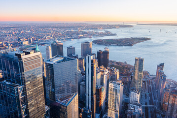 Skyline of Manhattan New York City during sunset. View of financial district and Governors Island.