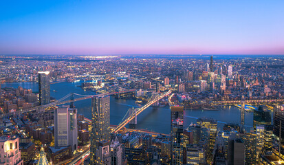 Skyline of Manhattan New York City during the night.View of Brooklyn and Manhattan Bridge over East...