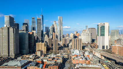 Skyline of Manhattan New York City from Brooklyn Bridge during the day.