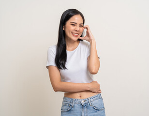 Pretty Young beautiful Asian woman standing smiling showing mini heart sign on cheek with isolated white background. Attractive Lovely Latin female wearing white shirt feeling surprised and happy.
