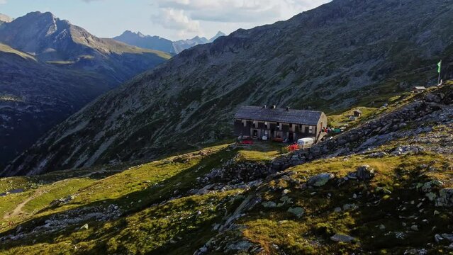 drone shot beautiful scenic view of European hut named "Olpererh&uuml;tte" in Austrian Alps in summer with the Schlegeis Stausee below