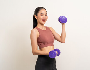 Young beautiful asian woman with sportswear exercises workout with dumbbells on isolated white background. Portrait happy healthy slim fit and firm latin attractive sporty woman weight training