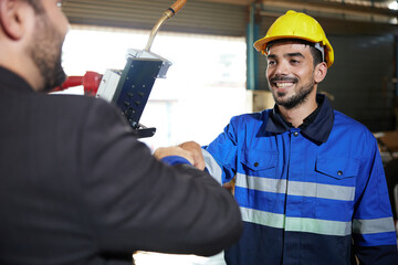 worker or engineer fist bump with businessman for agreement or success at works in the factory