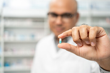 Professional asian man pharmacist checks inventory arrangement of medicine in pharmacy drugstore....