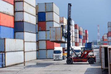 Container truck in a shipping yard with stacks of colorful containers Copy space background,...