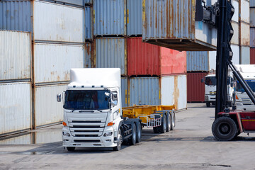 Container truck in a shipping yard with stacks of colorful containers Copy space background,...