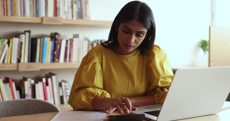 Employee do accountancy work, check profit, counting benefit and profit, manage corporate budget, calculates incomes and expenses, monitoring money movement sit a workplace desk with laptop in office