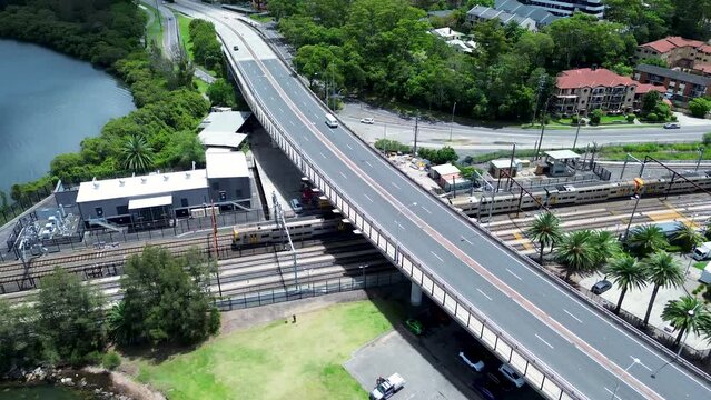 Drone aerial pan landscape train on tracks train-line railway Gosford station waterfront infrastructure travel transport Brian McGowan Bridge Central Coast Australia