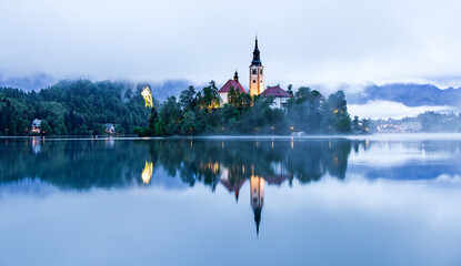 Lake Bled Slovenia with the small island in the middle of the lake and the old church and the castle in the background.