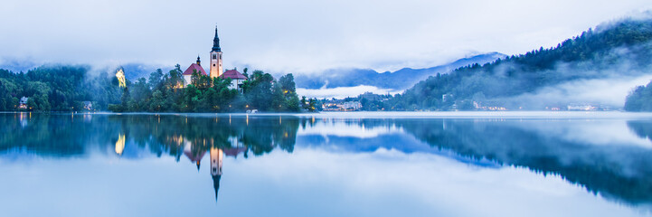 Lake Bled Slovenia with the small island in the middle of the lake and the old church at sunrise...
