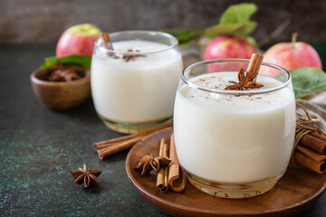 Autumn still life Background. Healthy nutrition: apple smoothie with cinnamon on a dark stone...