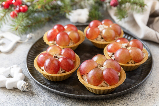 Christmas appetizers. Tartlets with chicken and grapes on the festive table.