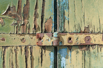 Layers of peeling paint on grungy old door close-up