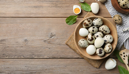 Fototapeta na wymiar Unpeeled and peeled boiled quail eggs in bowls on wooden table, flat lay