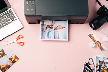 Printer, laptop and camera on table close up. Printing photos