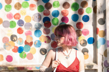 Obraz na płótnie Canvas fashion young creative girl , pink colored hair, posing at colorful wall background