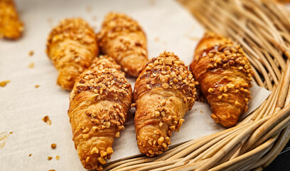 French almond croissants, Freshly baked Croissants pastry bread in the basket. Pastry Display Case, Bakery Display Case