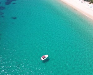 Top down of boat in crystal-clear water in Shoal Bay, NSW, Australia