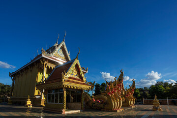 Fototapeta na wymiar Wat Si Bueng Bun located with the beautiful golden evening light at Sisaket province, Thailand