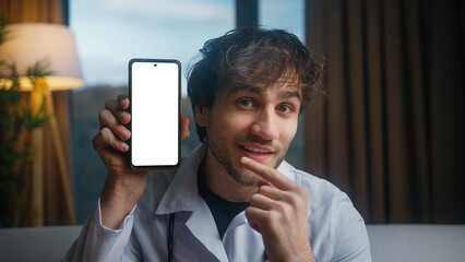 Young male doctor wear uniform with stethoscope show app on the phone screen. Doctor demonstrating...