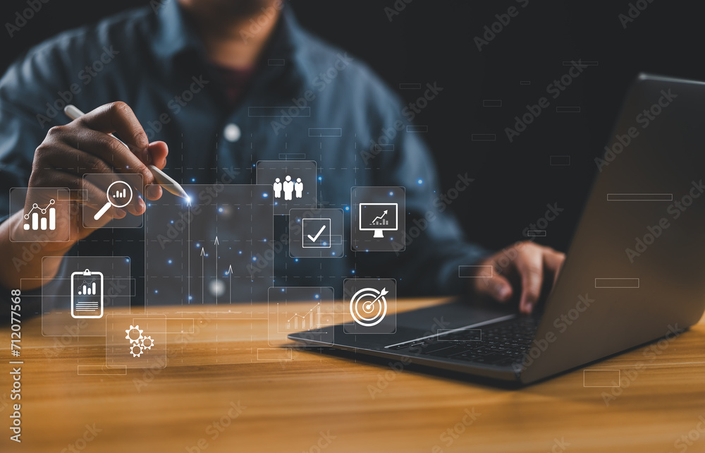 Poster businessman or analyst working with business analytics and data management system on virtual screen,
